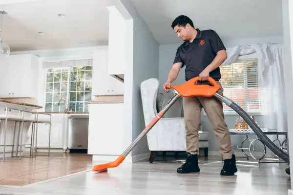 Technician extracting standing water from a Four Oaks floor